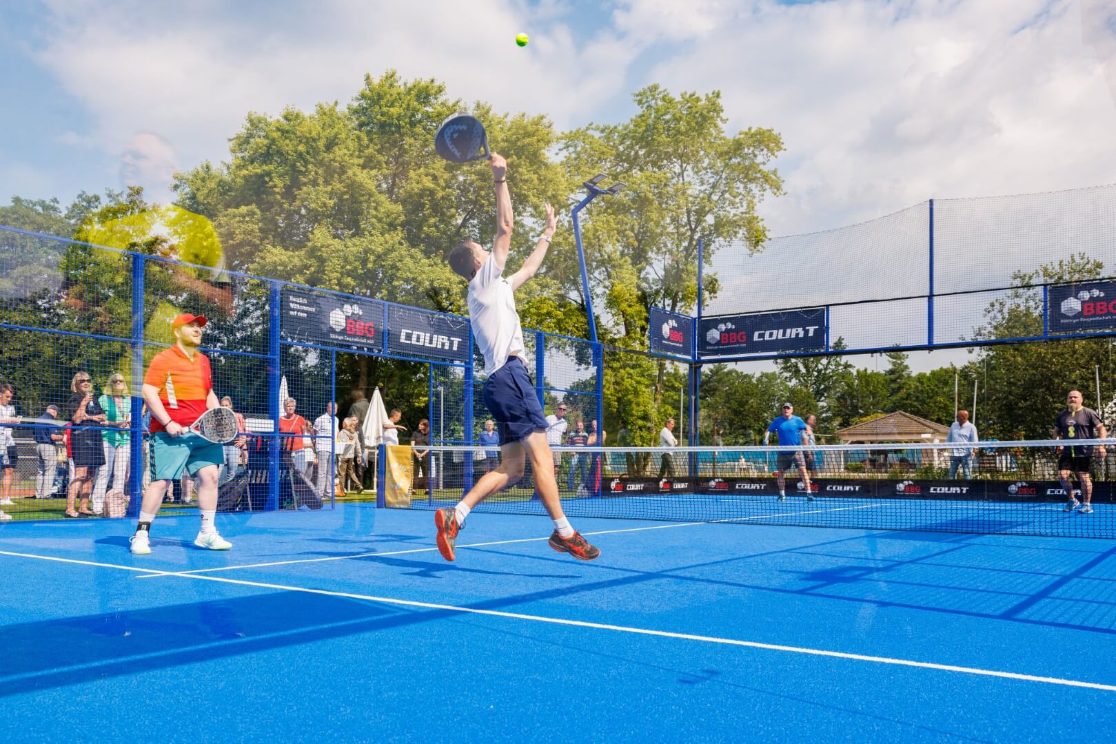 Padel-Spieler im Sprung auf dem blauen BBG-Padel-Court